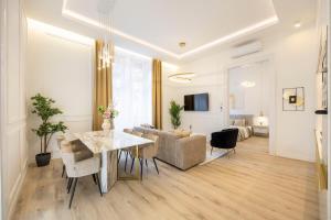 a living room with a table and a couch at Exclusive & Prestigious Central Residence w/ Balcony in Budapest