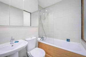 a bathroom with a toilet and a sink and a tub at Oxford Circus Station Apartment- Mayfair! in London