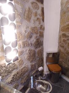 a bathroom with a toilet and a sink at Cottage Aldeia Da Serra - historic areas of Portugal in Celorico da Beira +22 photos