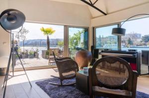 a living room with a view of the water at Loft sur l'eau avec parking in Paris