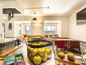 a store with a basket of fruit on a counter at ibis budget Bourges in Bourges