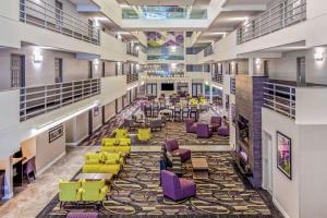 a large lobby with colorful chairs and tables at La Quinta by Wyndham Lubbock West Medical Center in Lubbock
