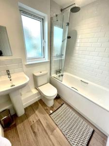 a bathroom with a toilet and a sink and a shower at Entire 3bed house close to westward ho/ town in Bideford
