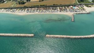 an aerial view of a beach and the water at Camping Fano in Fano