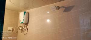 a phone is hanging on a wall in a bathroom at Om Bungalow in Dwarka