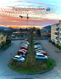 a parking lot with a bunch of cars parked at Diamond Apartments: Residenz Dreiländereck nahe Flughafen in Herten