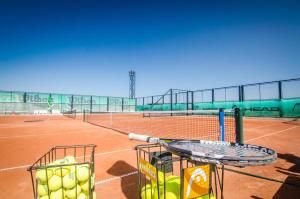 two baskets of tennis balls on a tennis court at Holiday Garden Resort in Sunny Beach