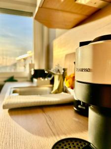 a close up of a kitchen counter with a microwave at Explore CH & FR - deluxe apartment Basel Airport in Herten