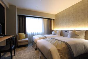 سرير أو أسرّة في غرفة في Best Western Plus Nagoya Sakae