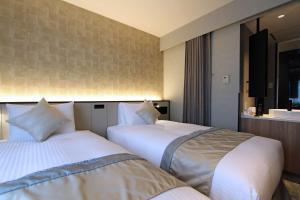 سرير أو أسرّة في غرفة في Best Western Plus Nagoya Sakae