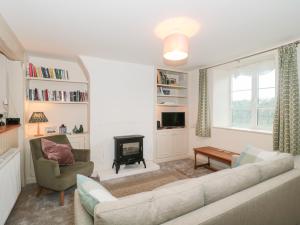 a living room with a couch and a fireplace at Bluebird Cottage in Castle Cary