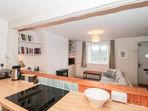 a kitchen and living room with a counter top at Bluebird Cottage in Castle Cary
