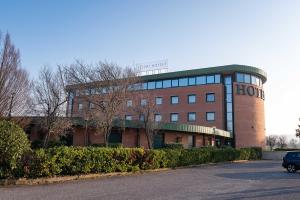 a building with a sign on top of it at Phi Hotel Emilia in Ozzano dell'Emilia