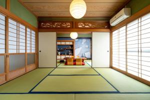 a japanese room with a carpeted floor at Shachihoko 海辺の一棟貸切ヴィラ しゃちほこ in Imari
