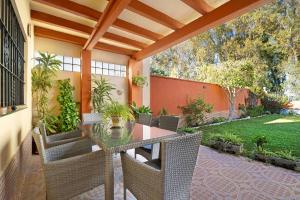 an outdoor patio with a table and chairs at Villa Valdelagrana in El Puerto de Santa María