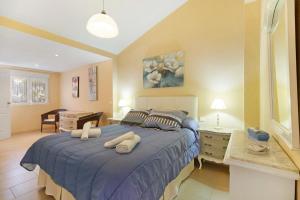 a bedroom with a large bed with two pillows on it at Villa Valdelagrana in El Puerto de Santa María +25 photos