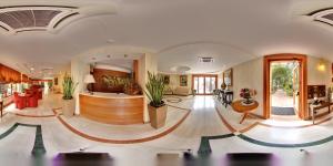a large lobby with a bar in the middle at Hotel Paradiso in Castellammare di Stabia