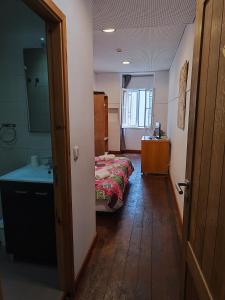 a room with a bed and a bathroom with a sink at House Rooms in Bairro Alto in Lisbon