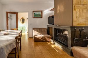 a living room with a fireplace and a table and chairs at Can Pons De Dalt Casa rural a la Selva in Girona