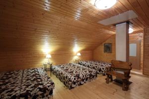 a room with three beds and a chair in it at Holiday Home MB Ranch in Bílá Hora