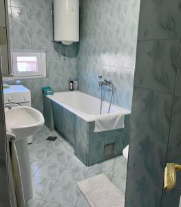 a bathroom with a tub and a sink at City Center Square DeLuxe Nest in Podgorica