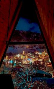 a view of a city from a window at night at Paradiso Mestia in Mestia
