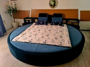 a large bed in a room with a blue bed frame at Pensiunea King in Timişoara