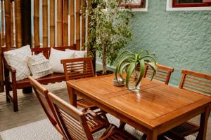 a wooden table with a potted plant on a patio at Fritz Manor Bed and Breakfast in Swakopmund