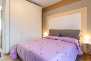 a bedroom with a bed with a purple comforter at Casadamare Salento in Brindisi
