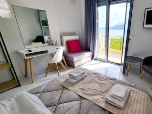 a bedroom with a bed and a desk with a view at Villa Serafeim in Kymi