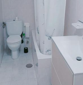 a white bathroom with a toilet and a shower at Veracruz Alquilevante in Benidorm