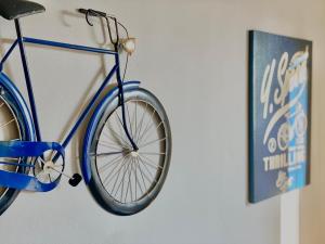 a blue bike hanging on a wall next to a sign at GuestReady-Close To Leeds City, Spacious, Sleeps 6 in Leeds