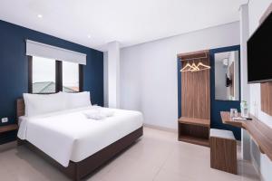 Voodi või voodid majutusasutuse Gold Hotel Simpang Lima toas