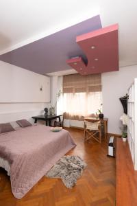 a bedroom with a bed and a red ceiling at sharing retro vintage luxury apartment in Bucharest