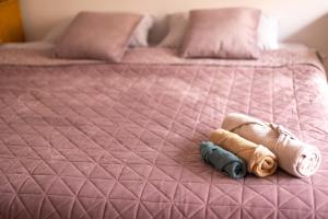 a pink bed with a stuffed animal on it at Shared Retro Vintage Luxury Apartment in Bucharest