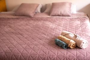 a pink bed with a stuffed animal on it at sharing retro vintage luxury apartment in Bucharest