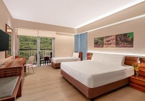 Voodi või voodid majutusasutuse Pico Sands Hotel toas