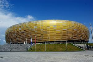 a large round building with a yellow at Baltika in Gdańsk