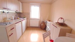 a kitchen with white cabinets and a window at Vojvoda in Belgrade