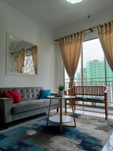 a living room with a couch and a table at NurAz Residensi Adelia2, Bangi Avenue, Free wifi, Pool in Kajang