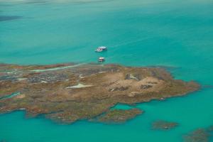 an island with a boat in the water at Setai Yacht Premium - By Almare Flats in João Pessoa