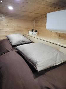 a room with two beds in a small room at Unwind Cabin Heisterberg in Driedorf