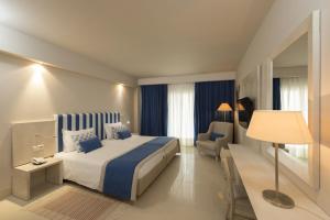 a hotel room with a bed and a chair at Iberostar Selection Diar El Andalous in Port El Kantaoui