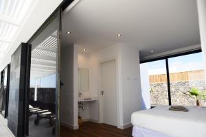 a bedroom with white walls and a large window at Duna Colorada in Lajares +101 photos