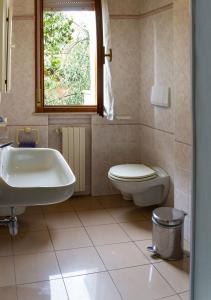 a bathroom with a sink and a toilet and a window at Residenza Novalba in Riccione