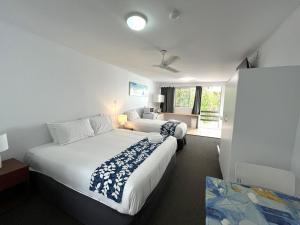 a hotel room with two beds and a window at Browns Broadbeach in Gold Coast