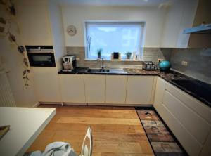 a kitchen with a sink and a window at Zonnezoen in De Panne