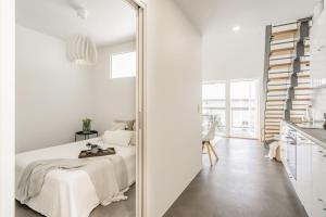 a mirror in a white room with a bed at Kotimaailma - Furnished Apartment in Vantaa with key code in Vantaa