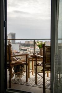 a balcony with a table and chairs and a window at Urban Jungle in the City Center in Timişoara