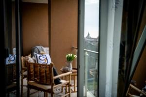 a balcony with chairs and a view of a building at Urban Jungle in the City Center in Timişoara